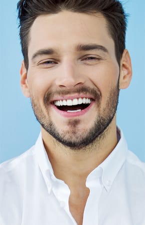 Man smiling with his newly restored smile - Restoration Dental